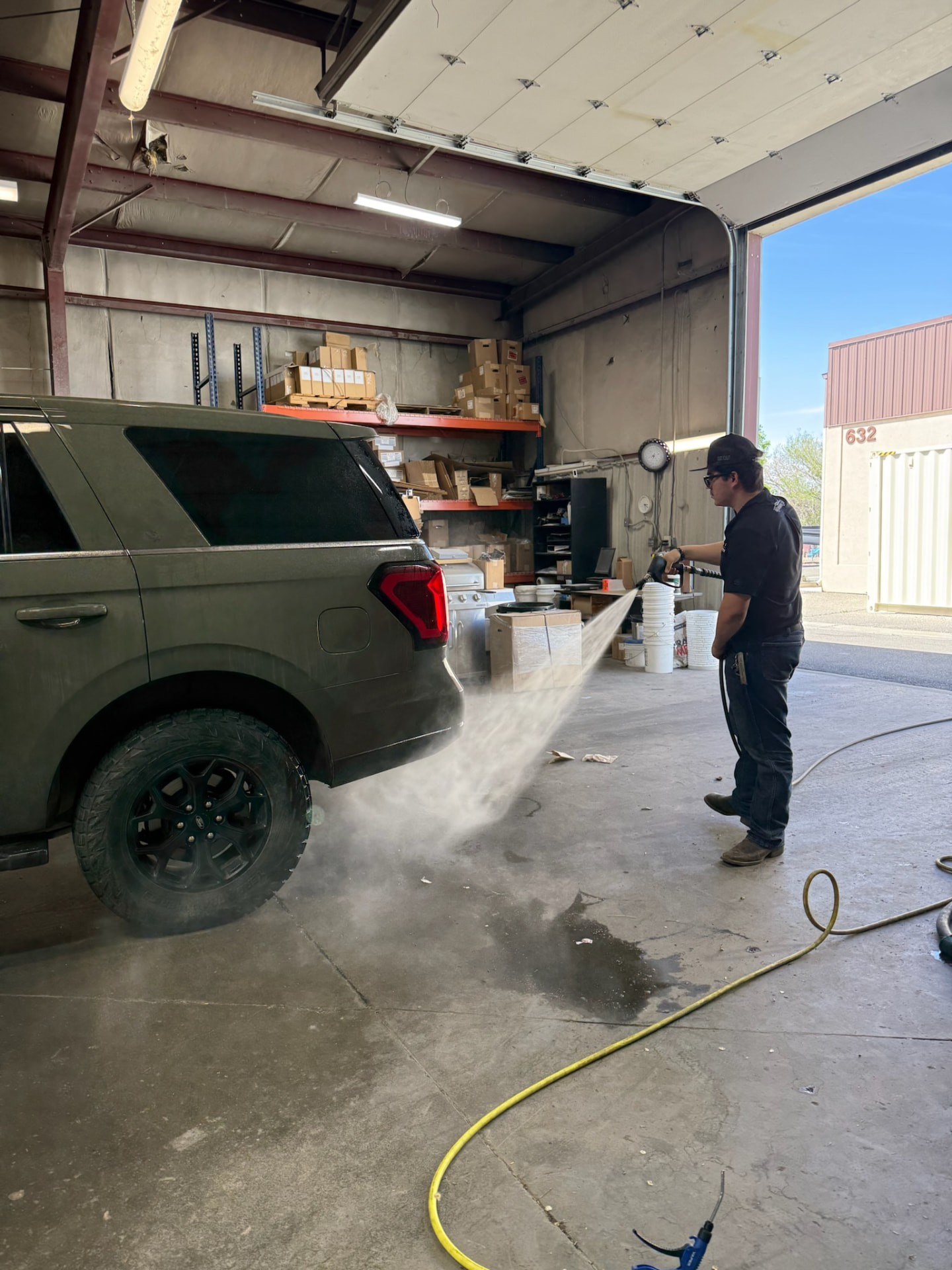 Pressure washing the rear quarter of the Ford Expedition