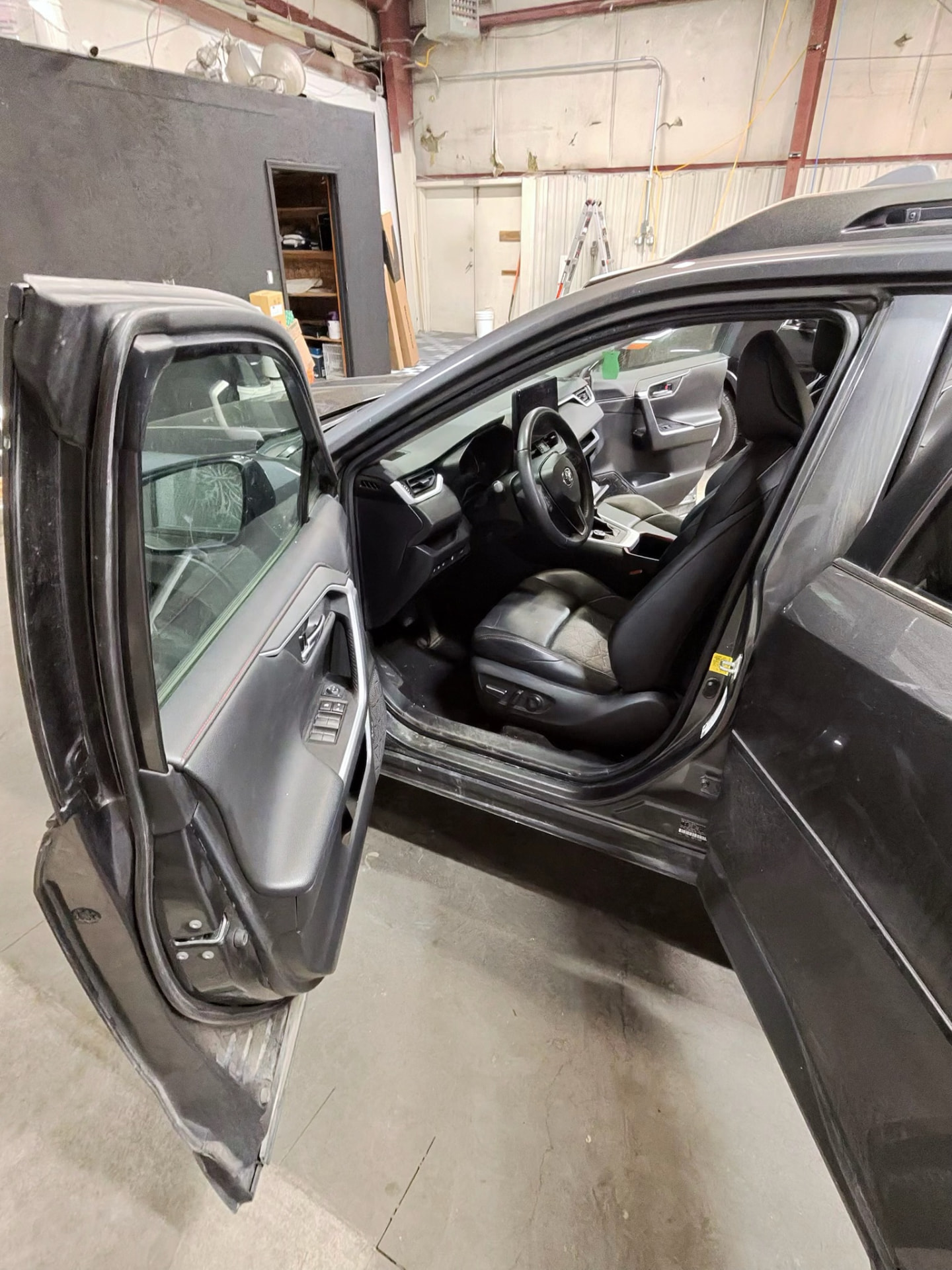 Front seats and dashboard of the RAV4 detailed in the shop bay